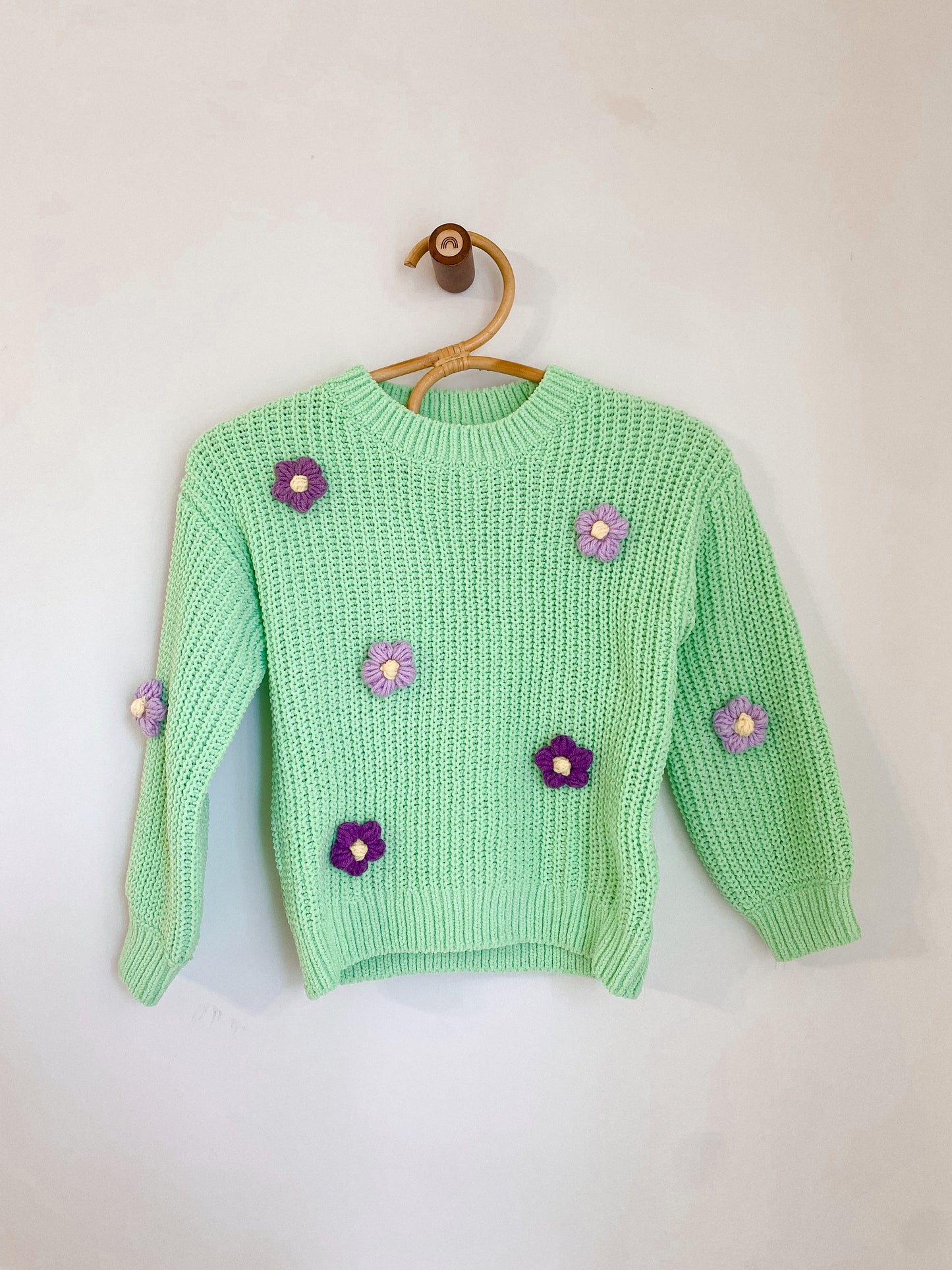 Sweater with crocheted flowers