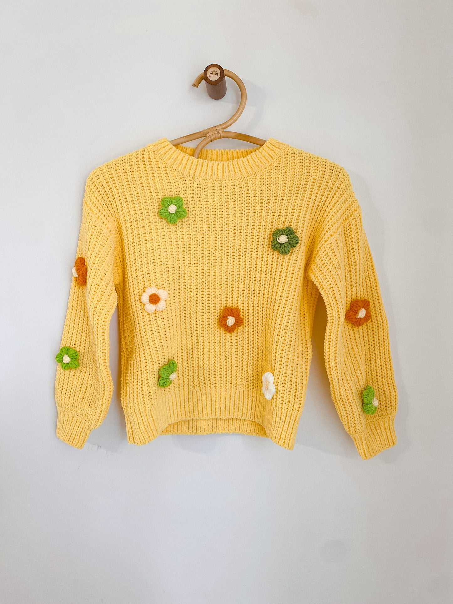 Sweater with crocheted flowers